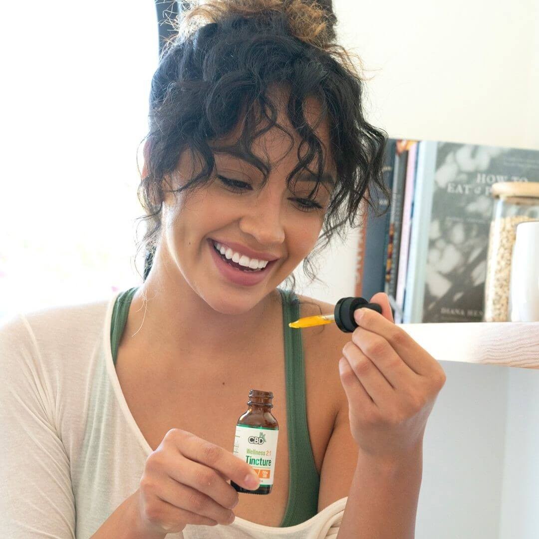 A girl using cbd oil